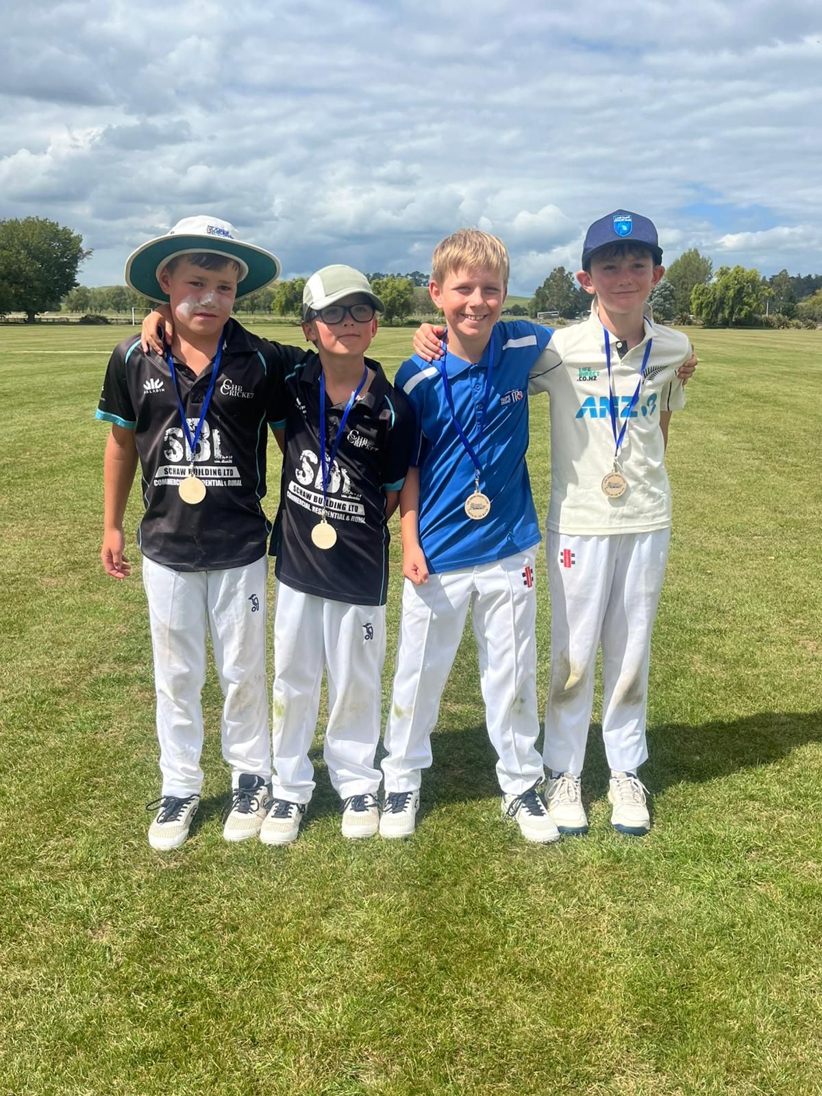 Four junior players with their medals