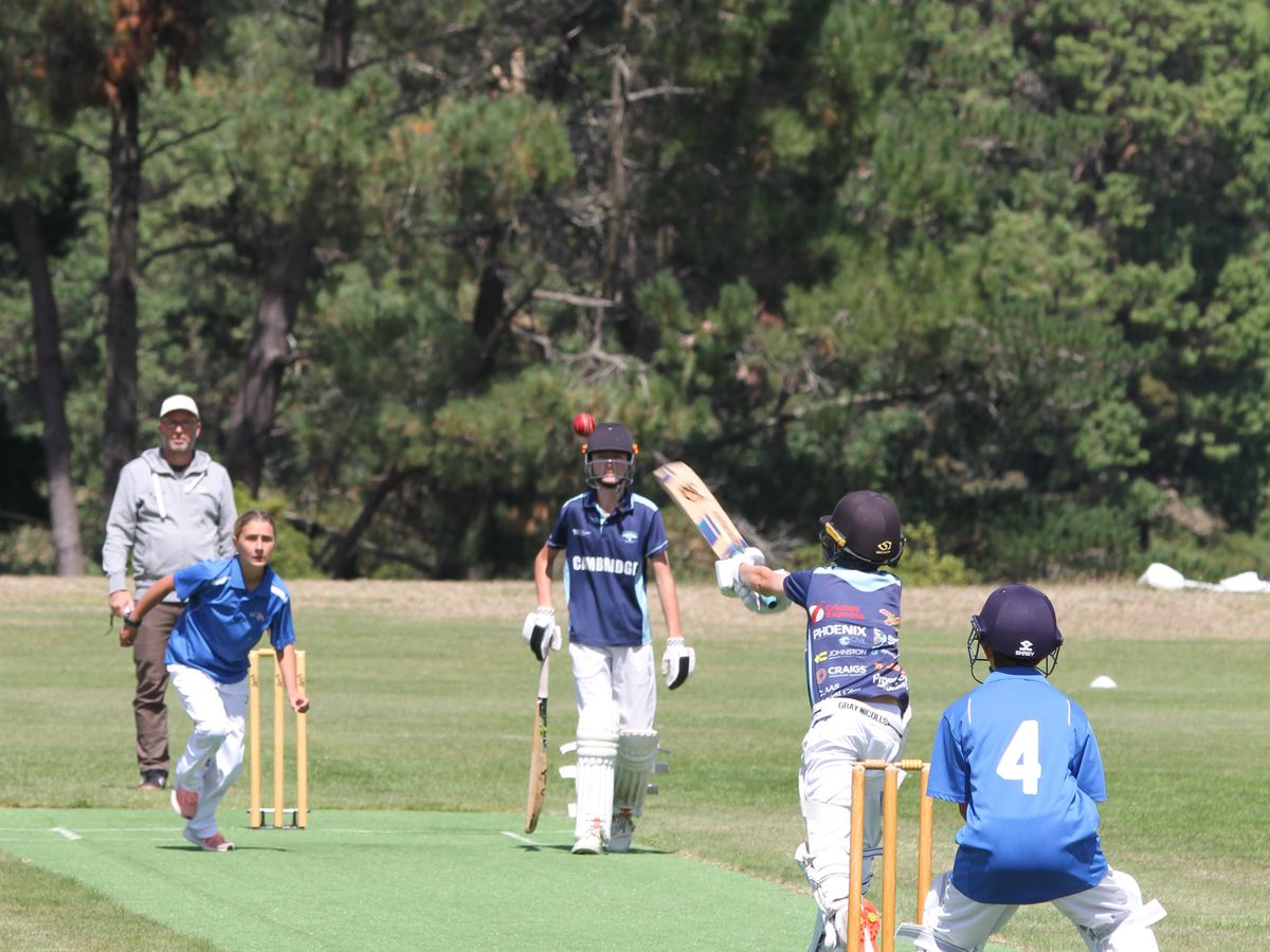 A junior batter playing a shot