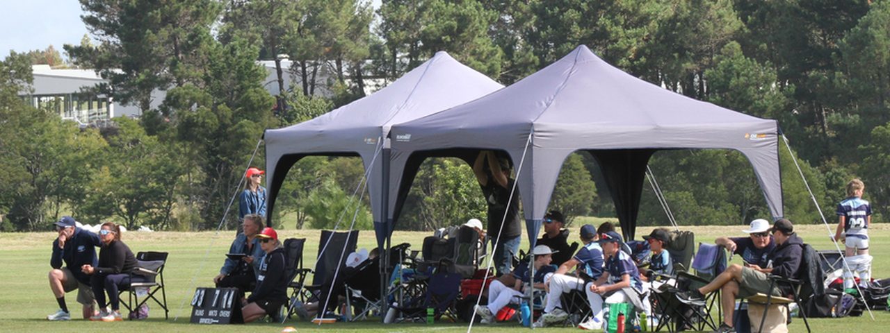 Parents and supporters watching from under the gazebos